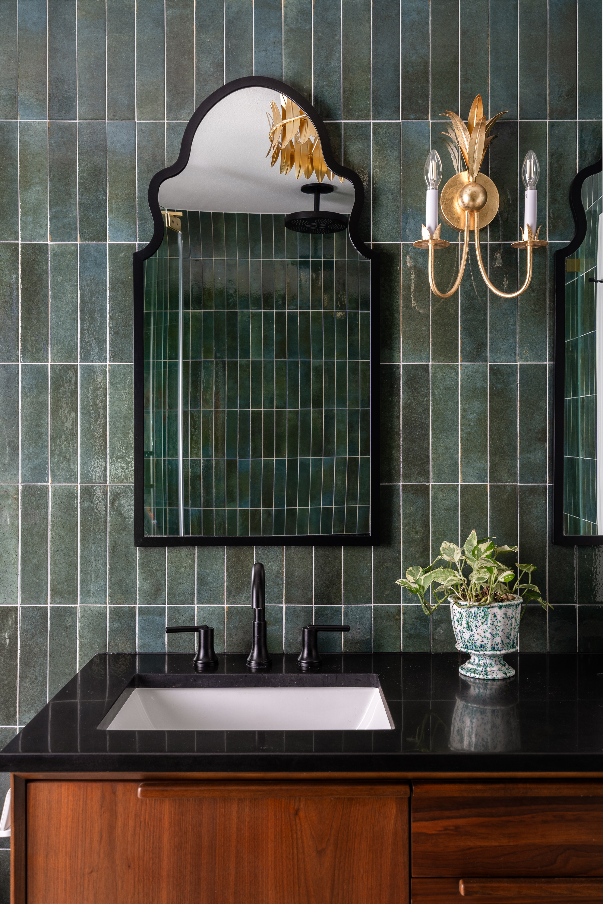 Green tile vanity with arched mirror