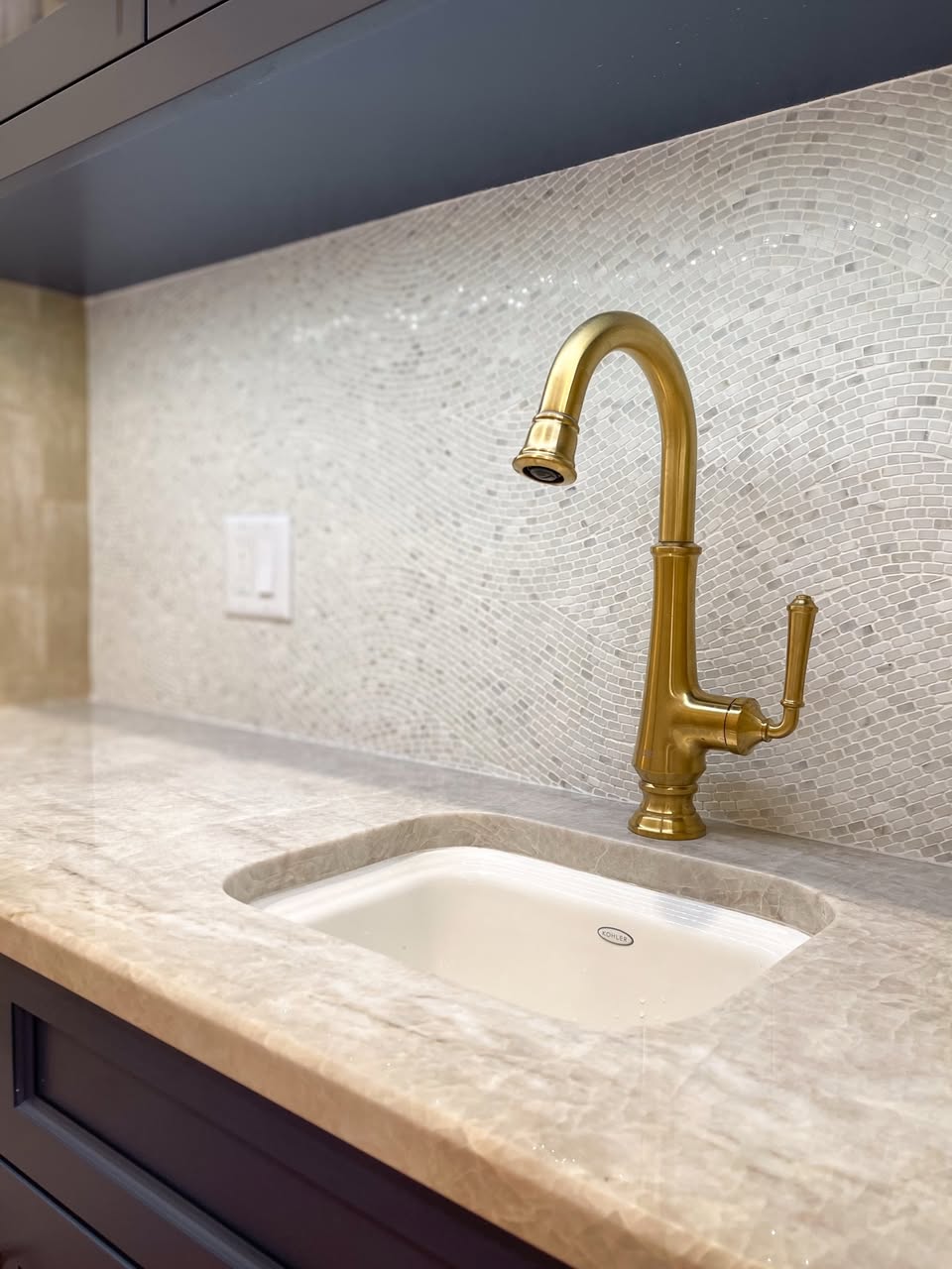 Gold faucet and marble counter detail
