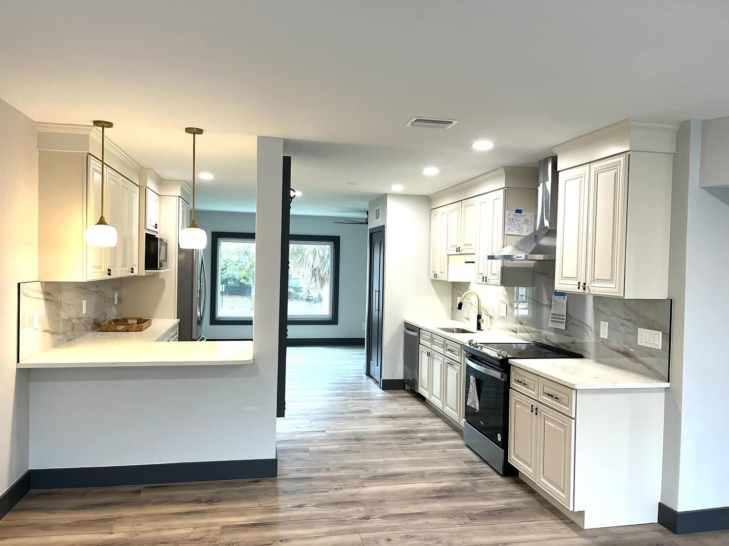 Open galley kitchen with white cabinets