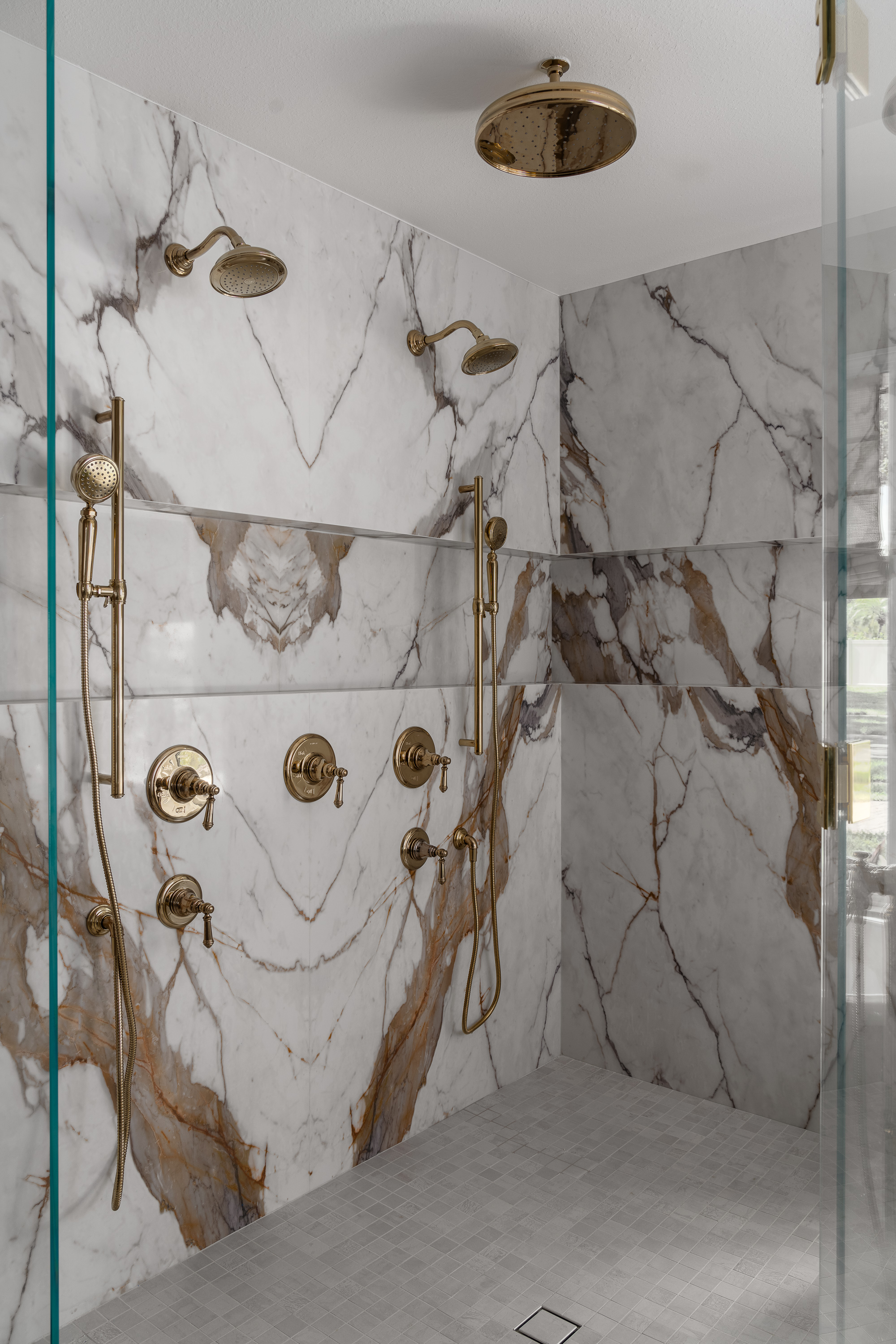 Marble shower with gold fixtures
